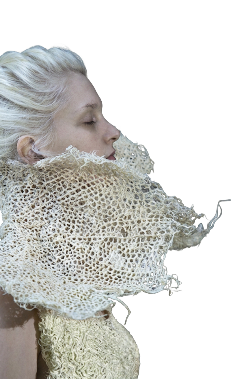 Portrait of a figure wrapped in delicate hand-knitted natural fibre, turned toward the text